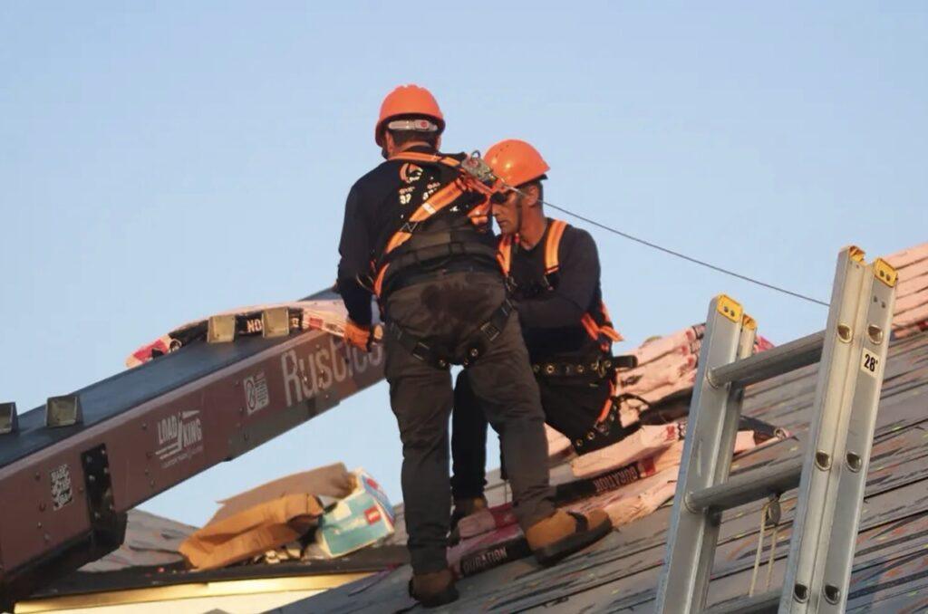 Roofing Supply in Florida Featured Image Men on Roof working using Roofing Supplies Large
